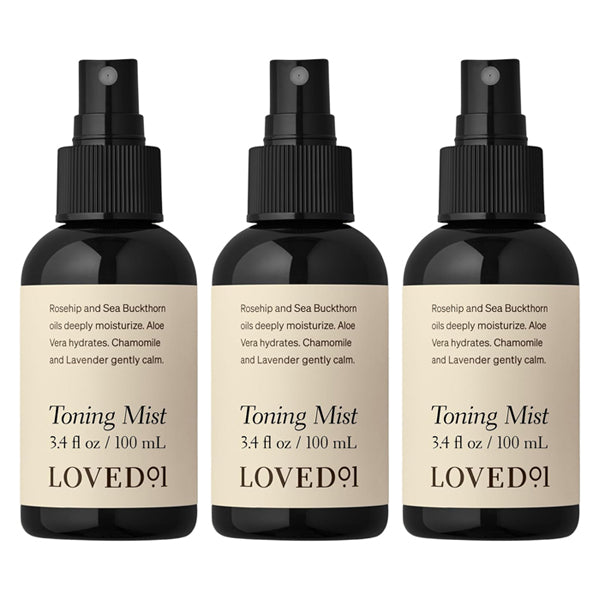 The Loved 01 3 Pack Face & Body Toning Mist Moisturizing Spray (3.4oz each) features black caps, beige labels, and vegan skincare details. Infused with witch hazel, the packaging lists ingredients and benefits.